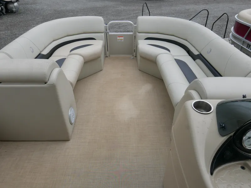 Slide: The Image of 2015 Lowe SS230 pontoon boat interior with beige seating and cup holders. - 8