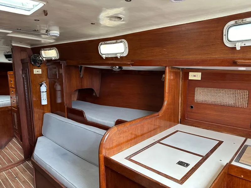 Slide: The Image of Interior of 1981 Tartan 37 sloop with wooden finish and seating area. - 6