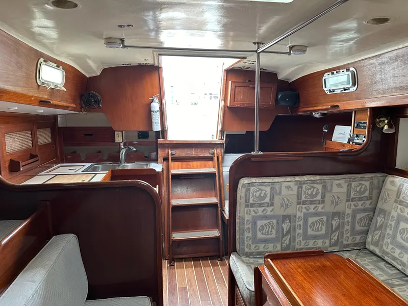 Slide: The Image of Interior of 1981 Tartan 37 sloop with wooden cabinetry and patterned seating. - 10