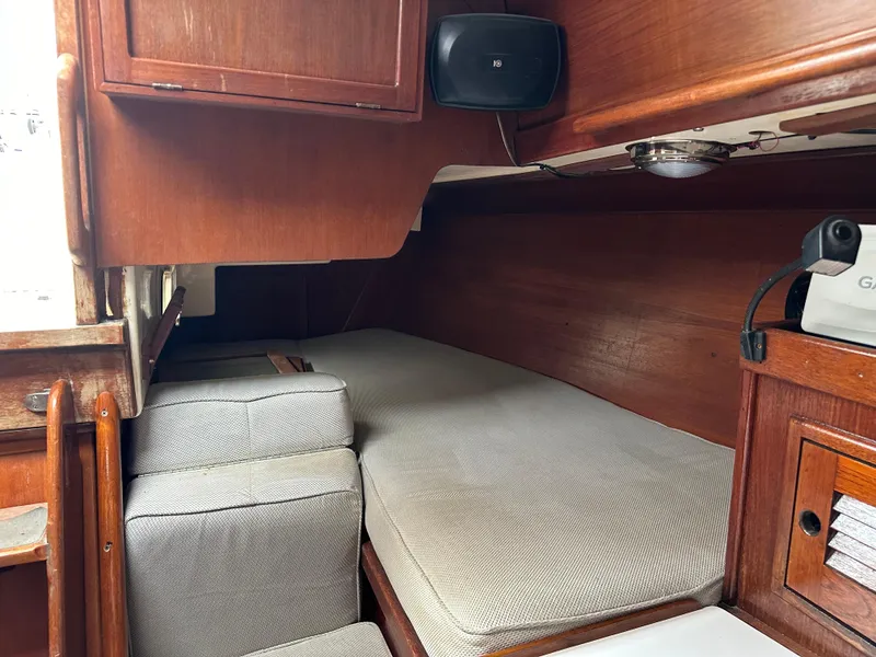 Slide: The Image of Interior cabin of 1981 Tartan 37 sloop with wooden finish and cushioned seating. - 12