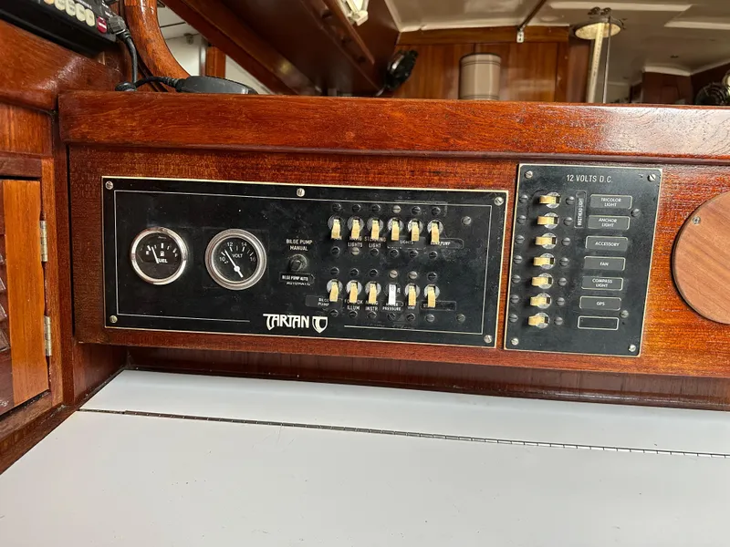 Slide: The Image of Control panel of a 1981 Tartan 37 sloop, featuring gauges and switches. - 13