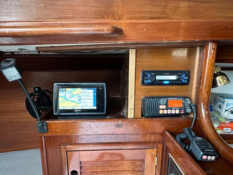 Slide: The Image of Navigation and communication equipment inside a 1981 Tartan 37 sloop sailboat cabin. - 18