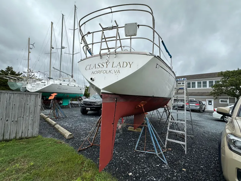 Slide: The Image of 1981 Tartan 37 sloop "Classy Lady" on land in Norfolk, VA, with overcast sky. - 2