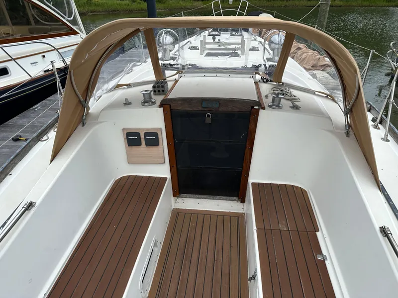Slide: The Image of 1981 Tartan 37 sloop cockpit with wooden seating and tan canopy. - 7