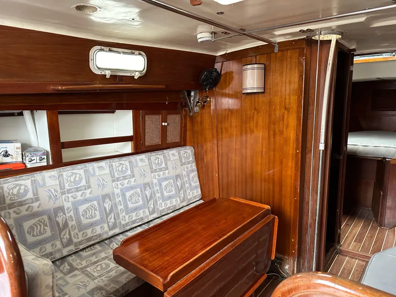 Slide: The Image of 1981 Tartan 37 sloop interior with wood paneling and patterned seating. - 8