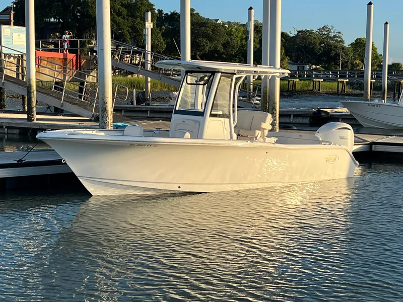 The Image of 2024 Sea Hunt Ultra 239 SE boat docked in a marina at sunset. - 0
