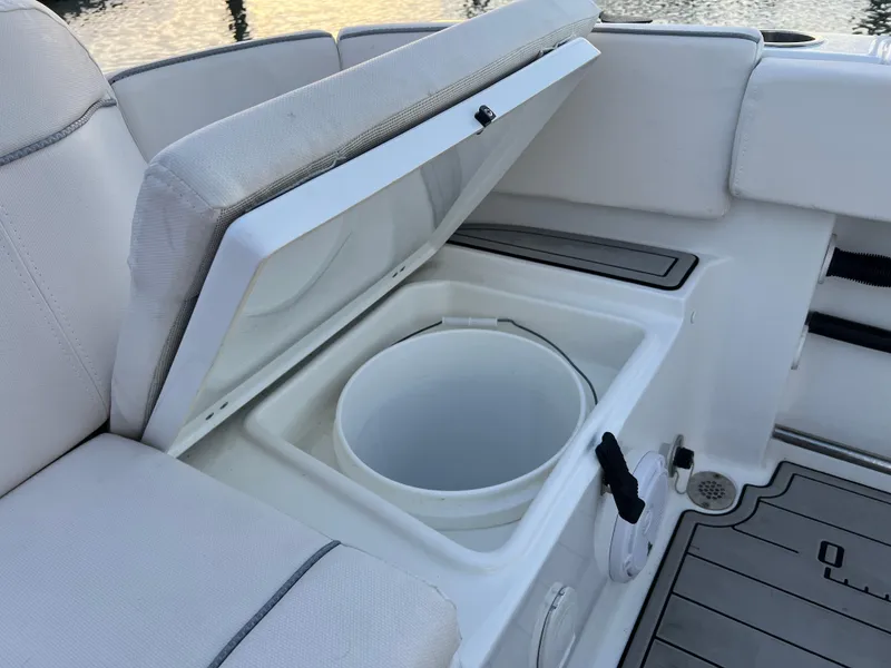 Slide: The Image of 2024 Sea Hunt Ultra 239 SE boat with open storage compartment and seating. - 11