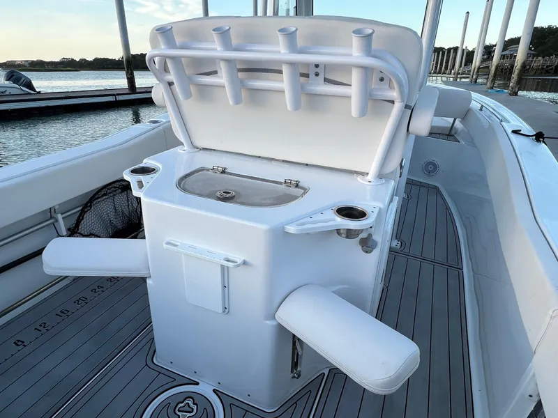 Slide: The Image of 2024 Sea Hunt Ultra 239 SE boat interior with fishing rod holders and seating. - 13