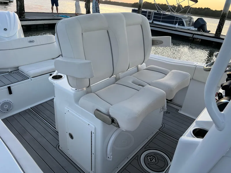 Slide: The Image of 2024 Sea Hunt Ultra 239 SE boat interior with white cushioned seating. - 18