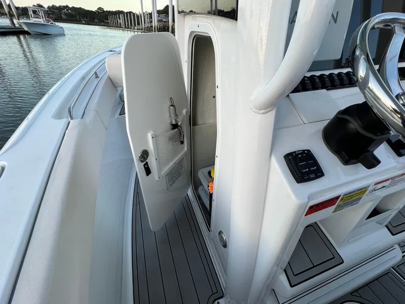 Slide: The Image of 2024 Sea Hunt Ultra 239 SE boat interior with open storage compartment. - 28