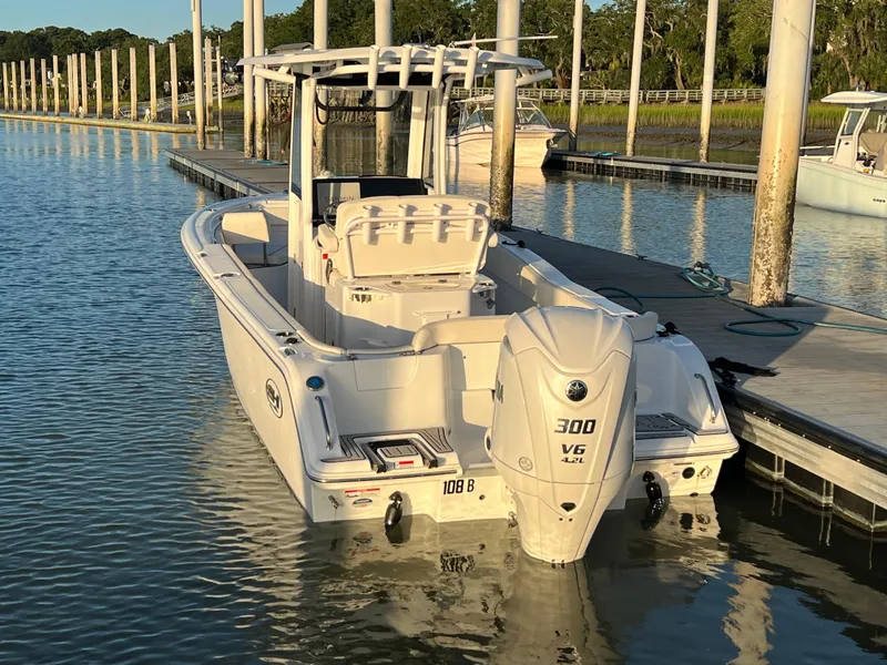 Slide: The Image of 2024 Sea Hunt Ultra 239 SE boat docked, featuring a powerful 300 V6 engine. - 3