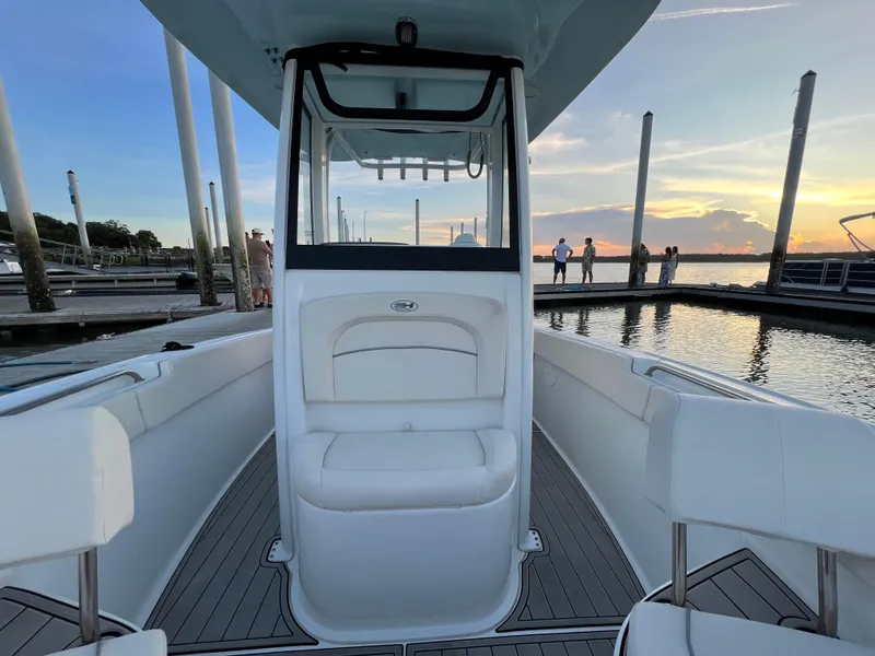 Slide: The Image of 2024 Sea Hunt Ultra 239 SE boat docked at sunset, featuring sleek interior design. - 33