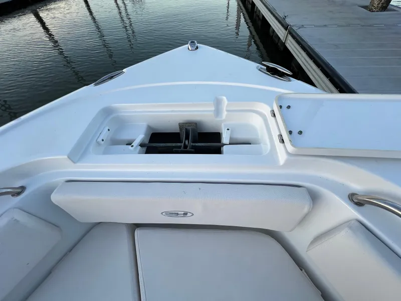 Slide: The Image of 2024 Sea Hunt Ultra 239 SE boat bow with anchor compartment and seating. - 34