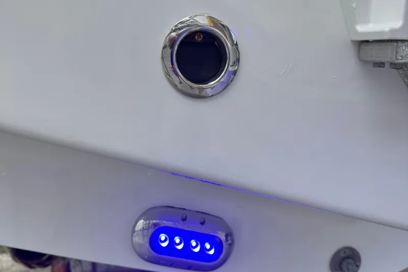 Slide: The Image of 2024 Sea Hunt Ultra 239 SE boat detail with blue LED lights and chrome fittings. - 36