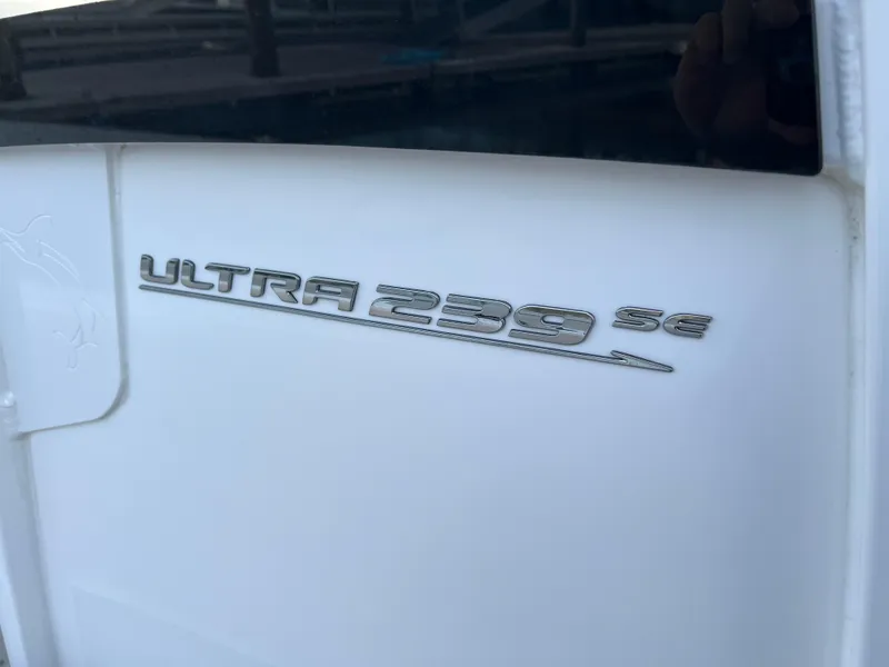 Slide: The Image of 2024 Sea Hunt Ultra 239 SE boat emblem on white surface. - 38