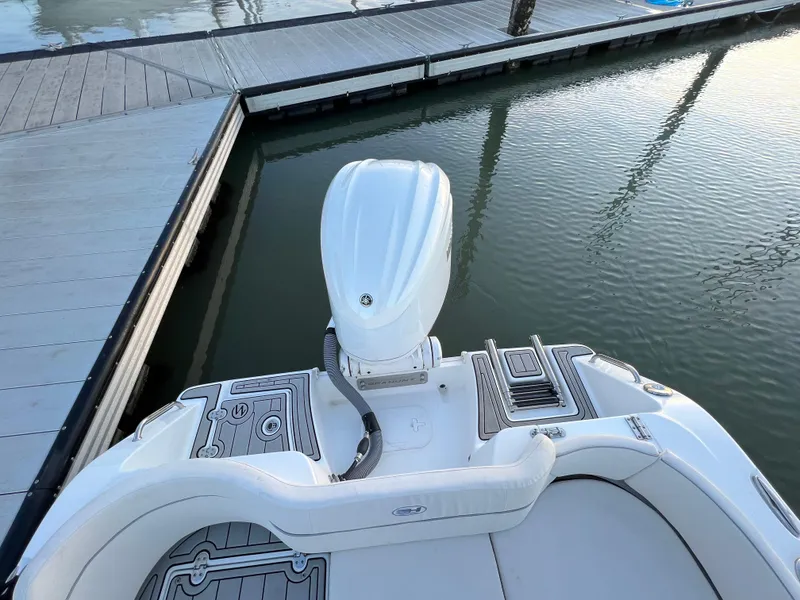 Slide: The Image of 2024 Sea Hunt Ultra 239 SE boat docked at marina, rear view. - 5