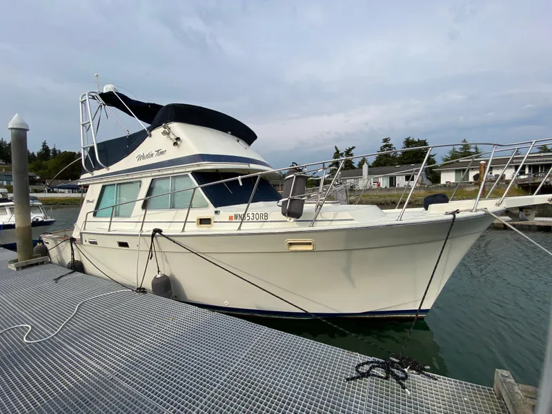 The Image of 1984 Tollycraft 34 Convertible Sedan docked at marina, side view. - 0