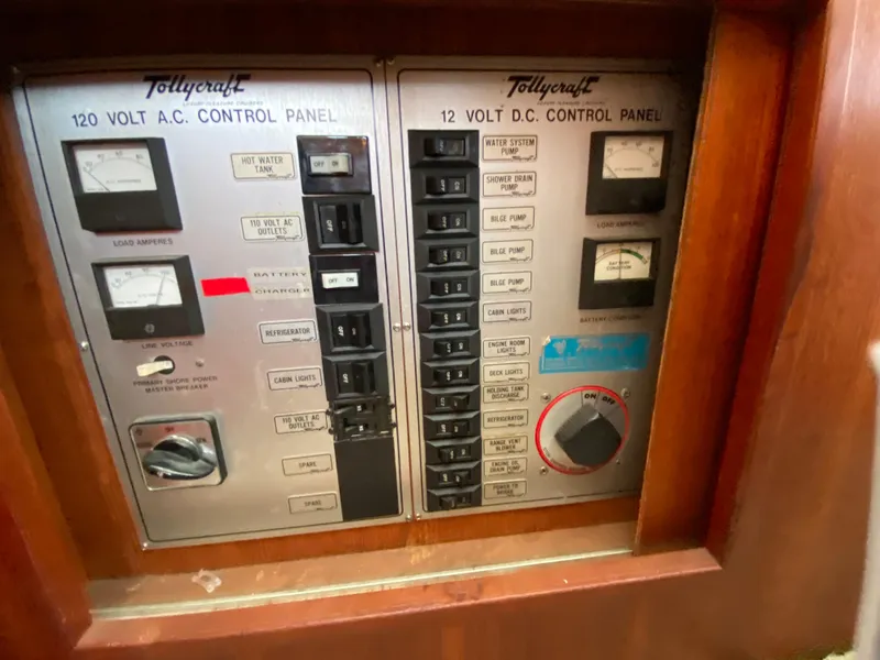 Slide: The Image of 1984 Tollycraft 34 Convertible Sedan control panel with 120V AC and 12V DC switches. - 21