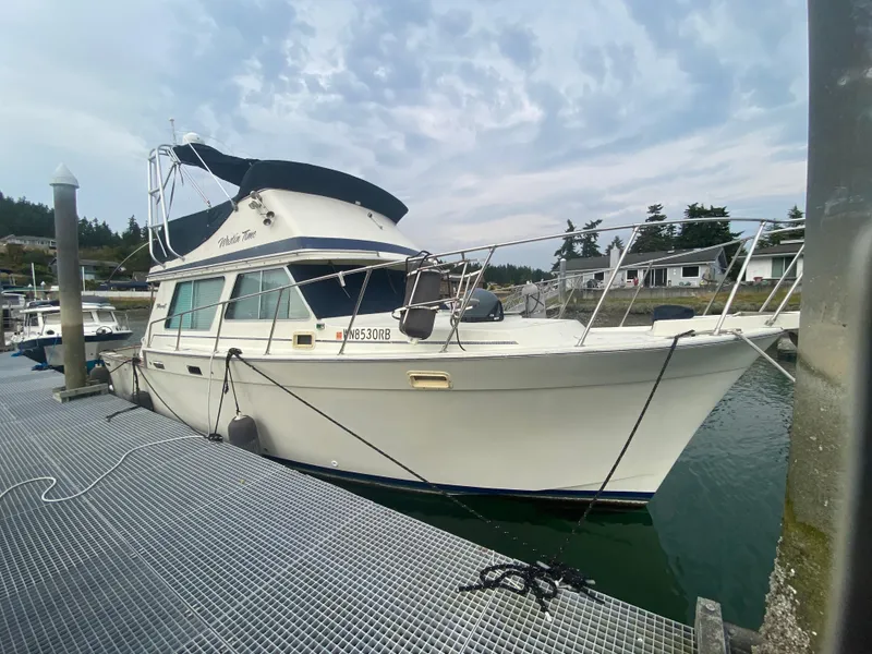 Slide: The Image of 1984 Tollycraft 34 Convertible Sedan docked at marina under cloudy sky. - 32