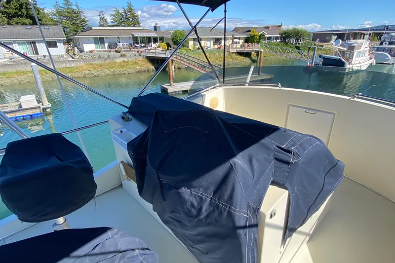 Slide: The Image of 1984 Tollycraft 34 Convertible Sedan boat docked near waterfront homes. - 39