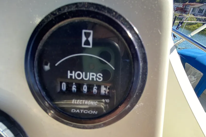 Slide: The Image of Hour meter on 1984 Tollycraft 34 Convertible Sedan showing 696.7 hours. - 44