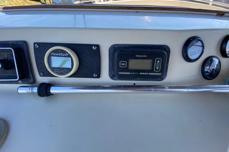 Slide: The Image of Control panel of a 1984 Tollycraft 34 Convertible Sedan with gauges and instruments. - 47