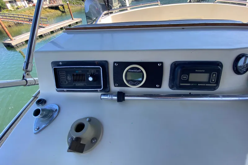 Slide: The Image of 1984 Tollycraft 34 Convertible Sedan dashboard with navigation instruments and controls. - 50