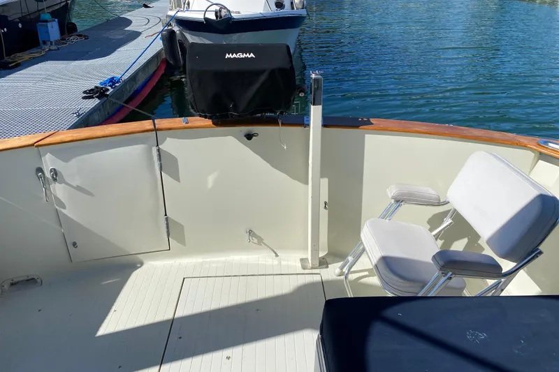 Slide: The Image of 1984 Tollycraft 34 Convertible Sedan boat deck with seating and water view. - 55