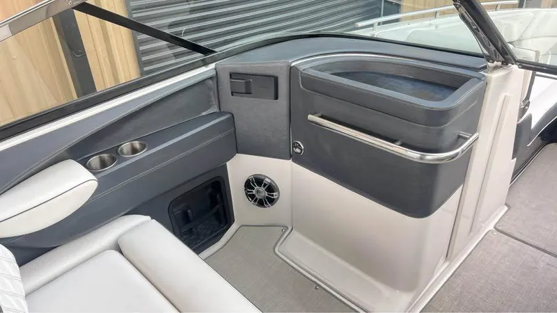 Slide: The Image of 2022 Regal 29 OBX boat interior with cup holders and speaker. - 11