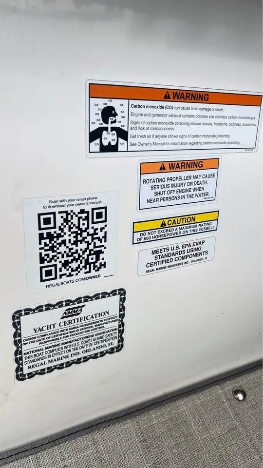 Slide: The Image of Warning labels and QR code on a 2022 Regal 29 OBX boat. - 17