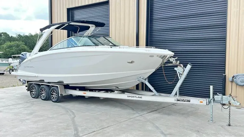 Slide: The Image of 2022 Regal 29 OBX boat on trailer, parked outside a building. - 4