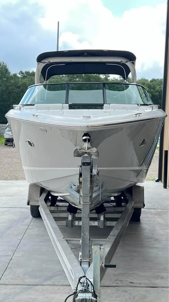 Slide: The Image of 2022 Regal 29 OBX boat on trailer, front view, parked outdoors. - 5