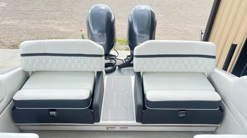 Slide: The Image of 2022 Regal 29 OBX boat with dual outboard engines and cushioned seating. - 9