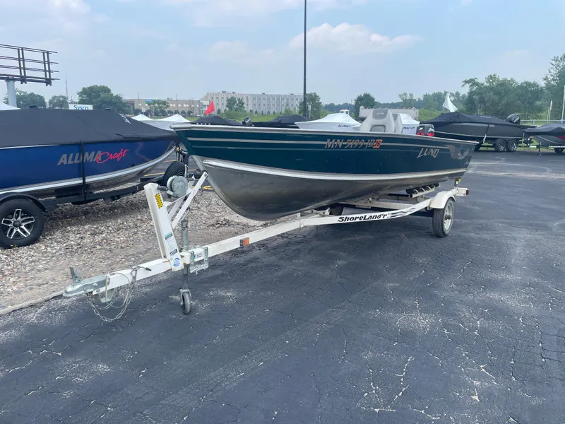 Slide: The Image of 2003 Lund 1650-V Rebel Tiller boat on trailer in parking lot. - 10