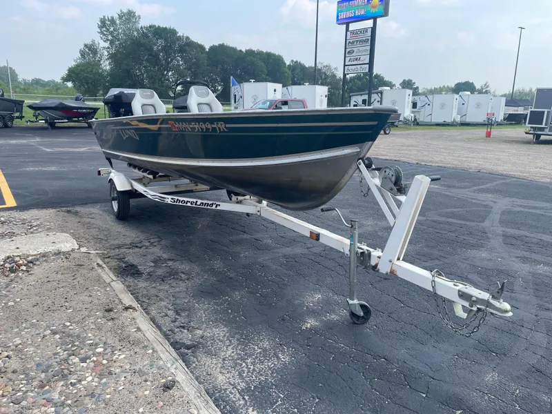 Slide: The Image of 2003 Lund 1650-V Rebel Tiller boat on ShoreLand'r trailer in parking lot. - 11