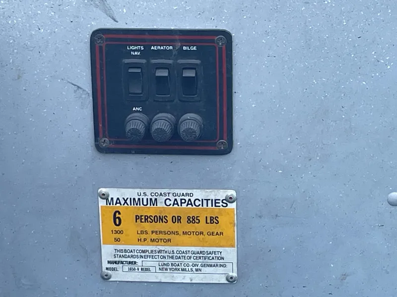 Slide: The Image of Control panel and capacity label on 2003 Lund 1650-V Rebel Tiller boat. - 19