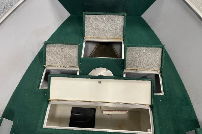 Slide: The Image of 2003 Lund 1650-V Rebel Tiller boat interior with open storage compartments. - 7