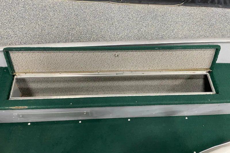 Slide: The Image of Open storage compartment in 2003 Lund 1650-V Rebel Tiller boat. - 9