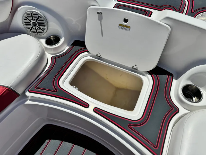 Slide: The Image of 2018 Tracker TAHOE 215 XI boat interior with open storage compartment and speaker. - 14