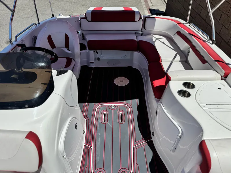 Slide: The Image of 2018 Tracker TAHOE 215 XI boat interior with red and white seating, steering wheel, and cup holders. - 15