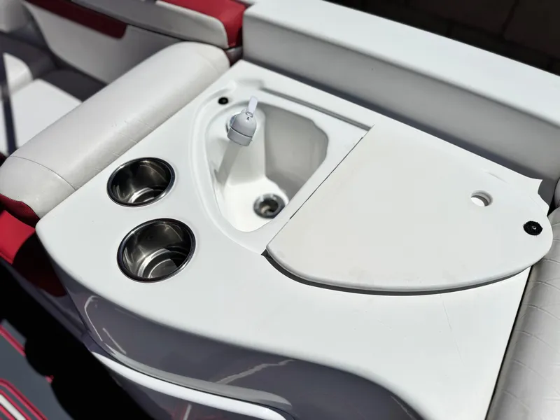 Slide: The Image of 2018 Tracker TAHOE 215 XI boat sink and cup holders on white and red seating. - 17