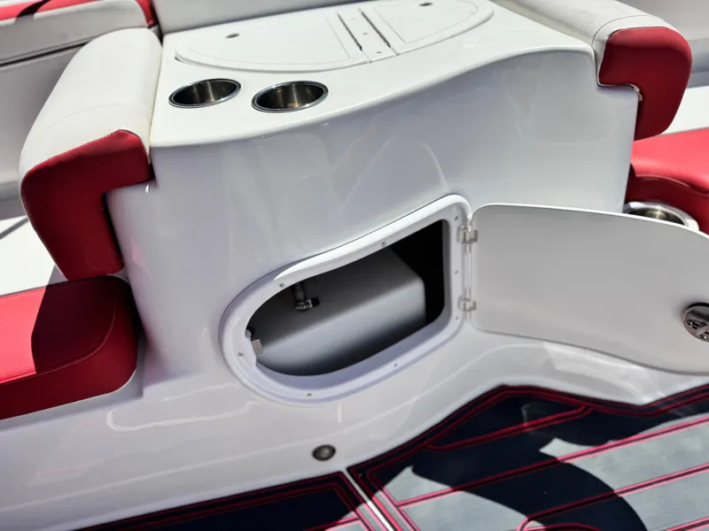 Slide: The Image of 2018 Tracker TAHOE 215 XI boat interior with open storage compartment and cup holders. - 18