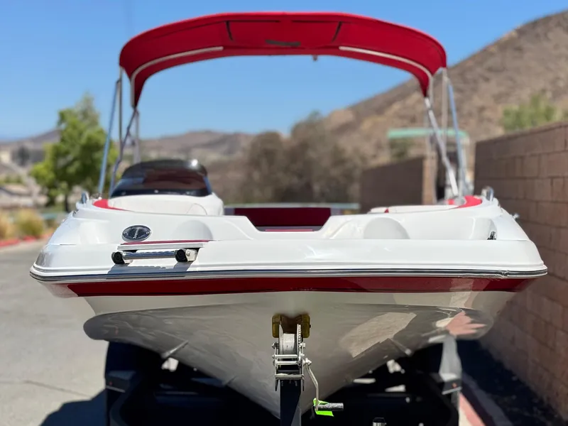 Slide: The Image of 2018 Tracker TAHOE 215 XI boat with red canopy, parked on trailer. - 2