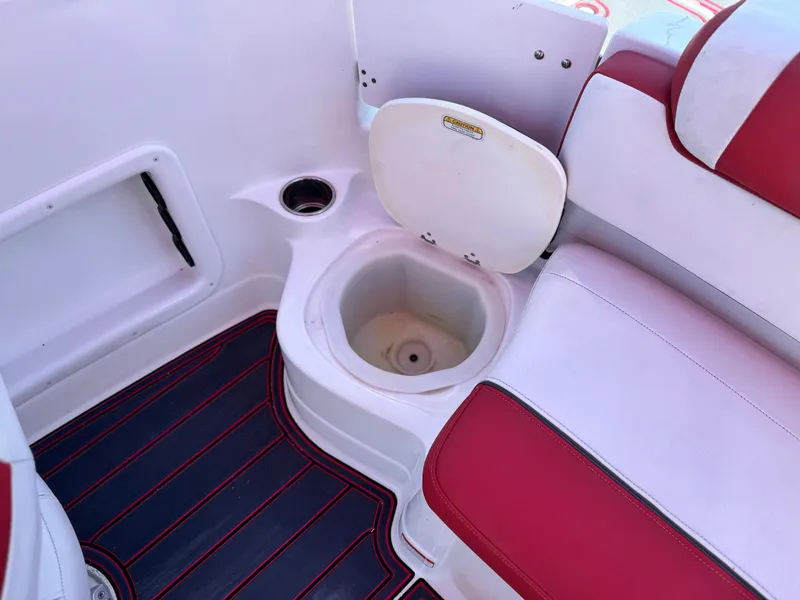 Slide: The Image of 2018 Tracker TAHOE 215 XI boat interior with red and white seating and storage compartment. - 22