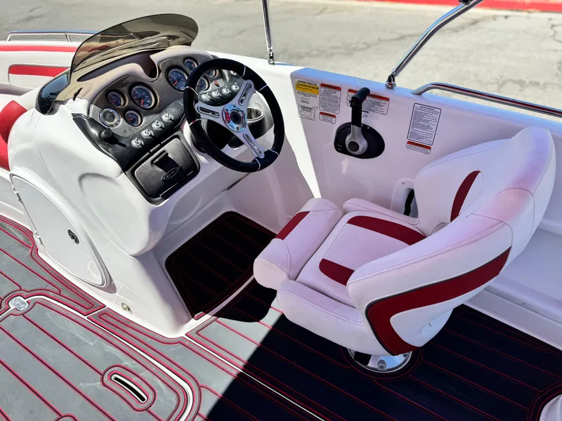 Slide: The Image of 2018 Tracker TAHOE 215 XI boat cockpit with steering wheel and captain's chair. - 27