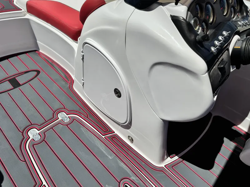 Slide: The Image of 2018 Tracker TAHOE 215 XI boat interior with red and gray flooring, white console, and red seating. - 31