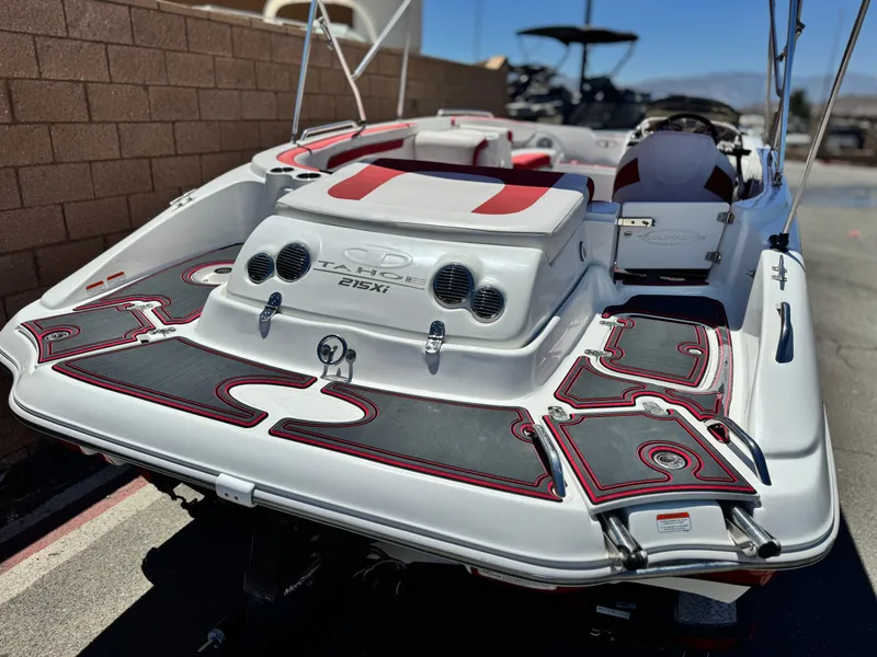 Slide: The Image of 2018 Tracker TAHOE 215 XI boat with red and black accents, docked outdoors. - 5