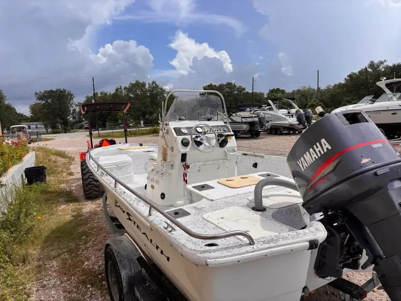 Slide: The Image of 2000 Bay Stealth 1880 Liner boat with Yamaha motor in a marina setting. - 5