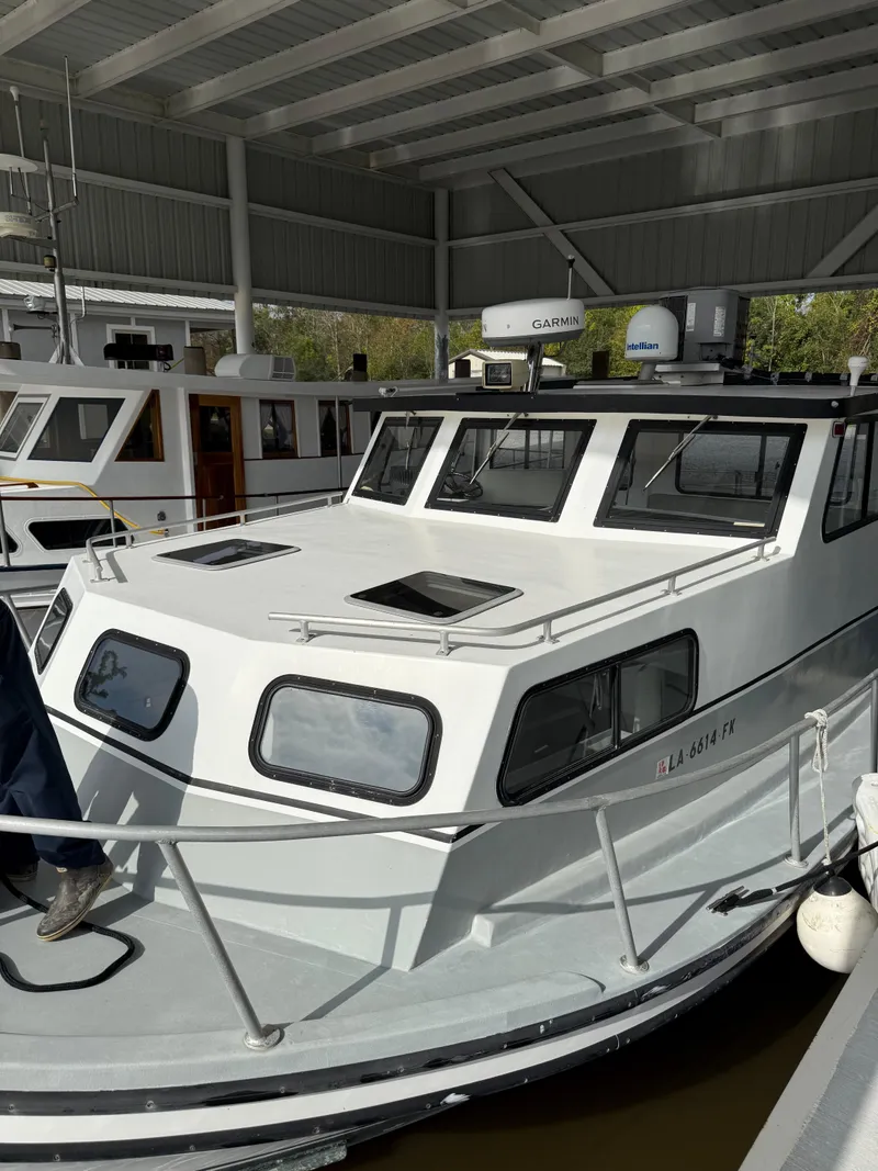 Slide: The Image of 2004 Jefferson Lafitte boat docked under a covered marina. - 2