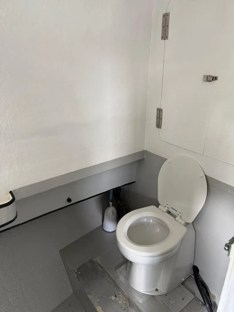 Slide: The Image of Small bathroom with a white toilet and cleaning brush, Jefferson Lafitte 2004 model. - 9